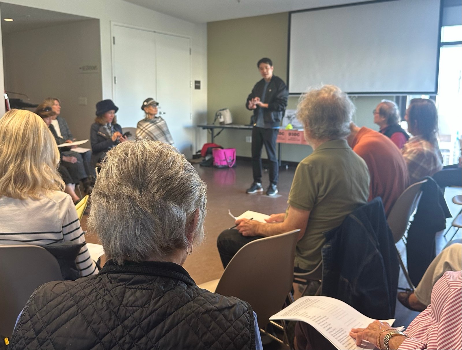 Jeremy Lee speaking with community members at a campaign event